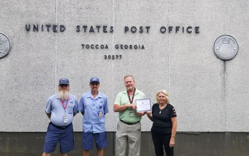 Pictured are (from left) Toccoa postal worker and U.S. Navy veteran Joe Shrode, postal worker and U.S. Army veteran Michael Waddell, Toccoa postmaster Brett Franklin and VFW Auxiliary senior vice president Martha Dysinger.