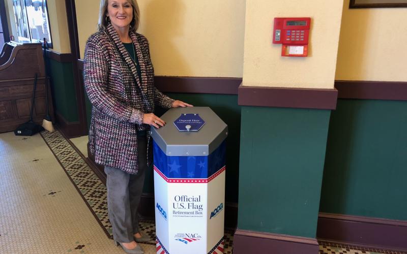 County clerk Beth Rider with the new flag disposal box.