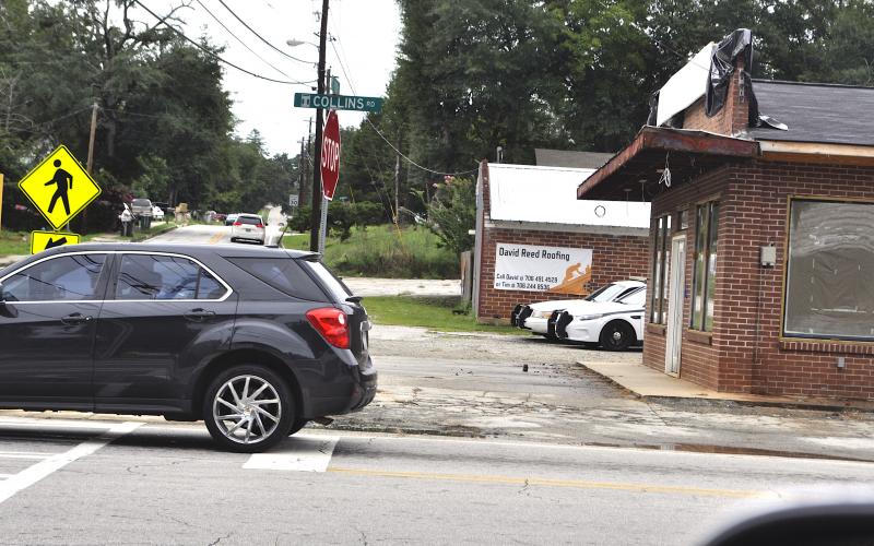 A pair of police cruisers peek out from behind the old Hemphill’s Store building being turned into a Toccoa P.D. substation. Work on the building has been delayed, city manager Billy Morse said.