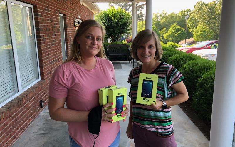 Michelle Sheriff (left) donated three laptop computers to Dr. Cynthia Shephed (right) and the cancer treatment center on Falls Road.