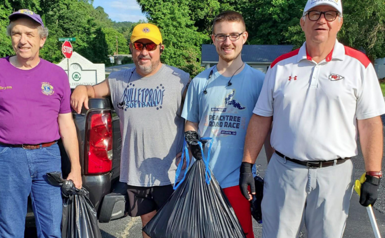 Pictured are Lions Club members resting after cleaning up litter along Falls Road last Saturday.  They are (from left) Bryan Gordon, Tim McLaughlin, Jack McLaughlin and Jack McLaughlin. Lions not pictured are Brenda Gordon, Jack Barnard and Dan Huff.  