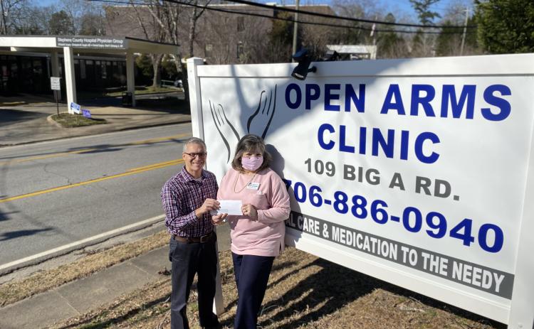 Pictured are the Rev. Andy Childs (left) presenting the grant award to Sherry Beavers, executive director of Open Arms Clinic. 
