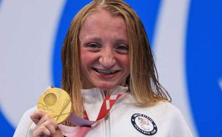McKenzie Coan shows off the gold medal she won Sunday in the 400 meter freestyle event of the 2020 Paralympic Games in Tokyo.
