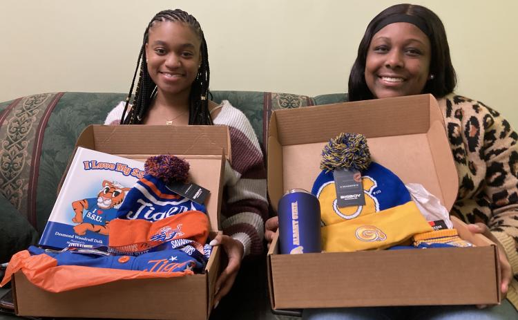 Jaylee Scott (left) and  Shakira Howard show off the contents of their College Care boxes.