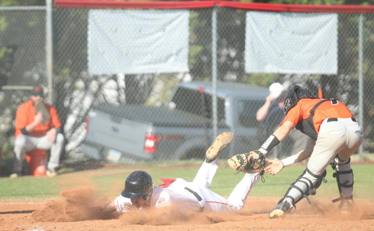 Senior Ethan Smith slides into a base during one of the Indians’ baseball games last week.
