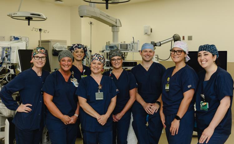 The operating room team at Northeast Georgia Medical Center Gainesville poses for a photo before completing the state of Georgia's first histotripsy procedure on Friday, April 19, 2024. From L-R: Caroline Chotas, RN; Kristy Foutty, CST; Casey Patton, RN, CNOR; Stephanie Sullins, CST; Shannon Sutton, RN, CNOR; Nelson Royall, MD; Ambar Riffi Temsamani, PA-C; Cierra Triggs, CST.